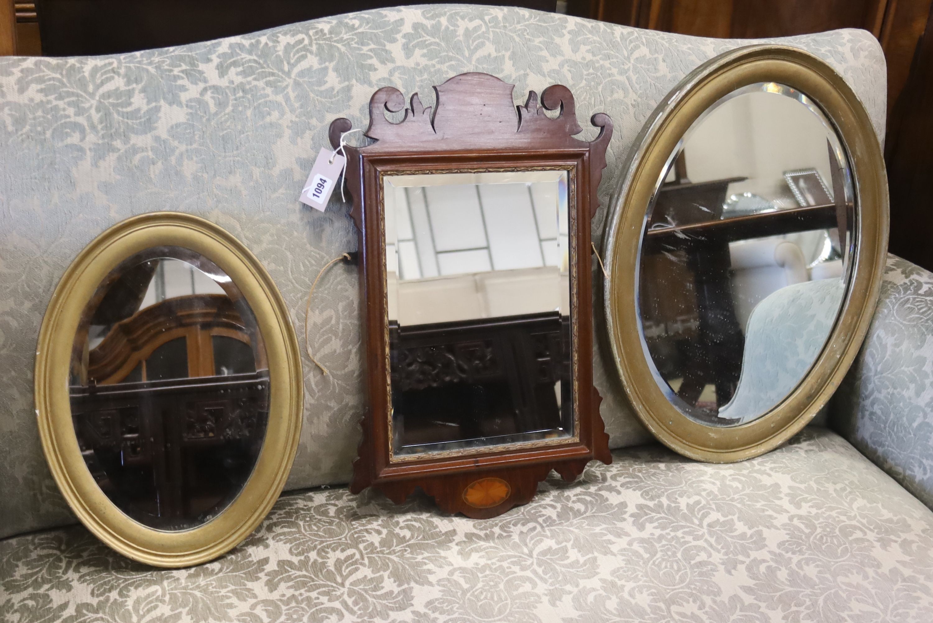 A small George III style inlaid fret cut wall mirror, height 56cm and two oval gilt framed wall mirrors